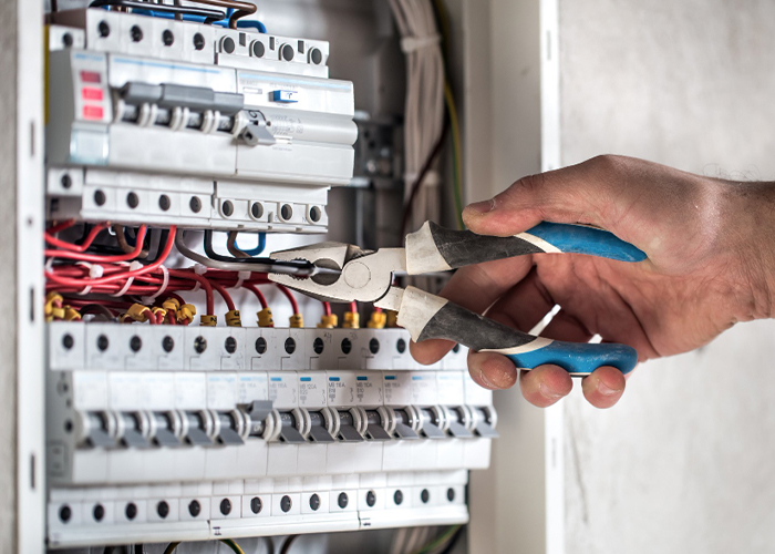 an-electrical-technician-working-in-a-switchboard-with-fuses