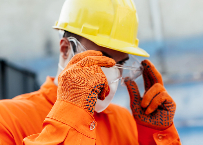 worker-in-uniform-with-hard-hat-and-protective-glasses